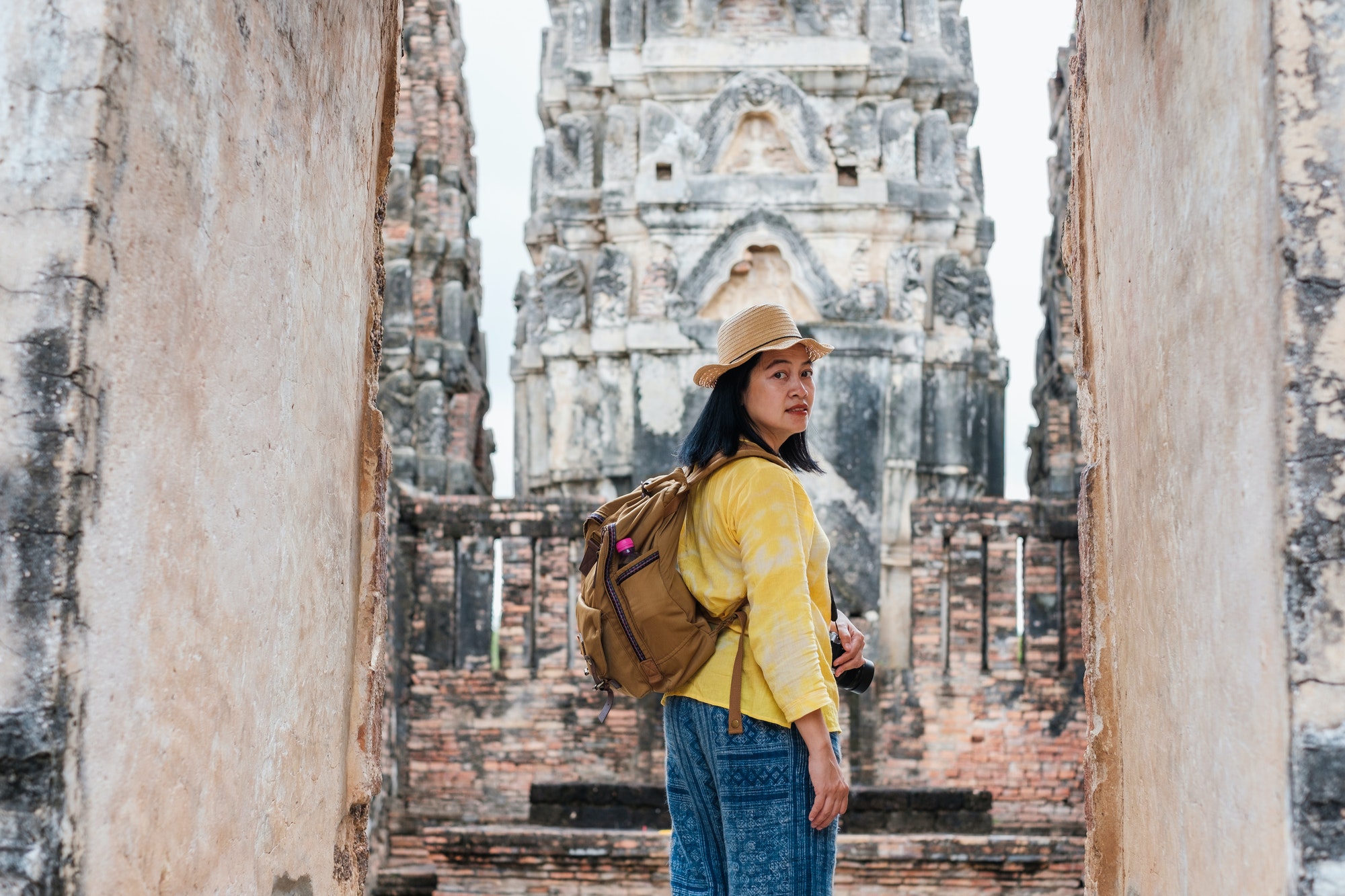 Asian tourist woman travel at ancient of pagoda temple thai architecture